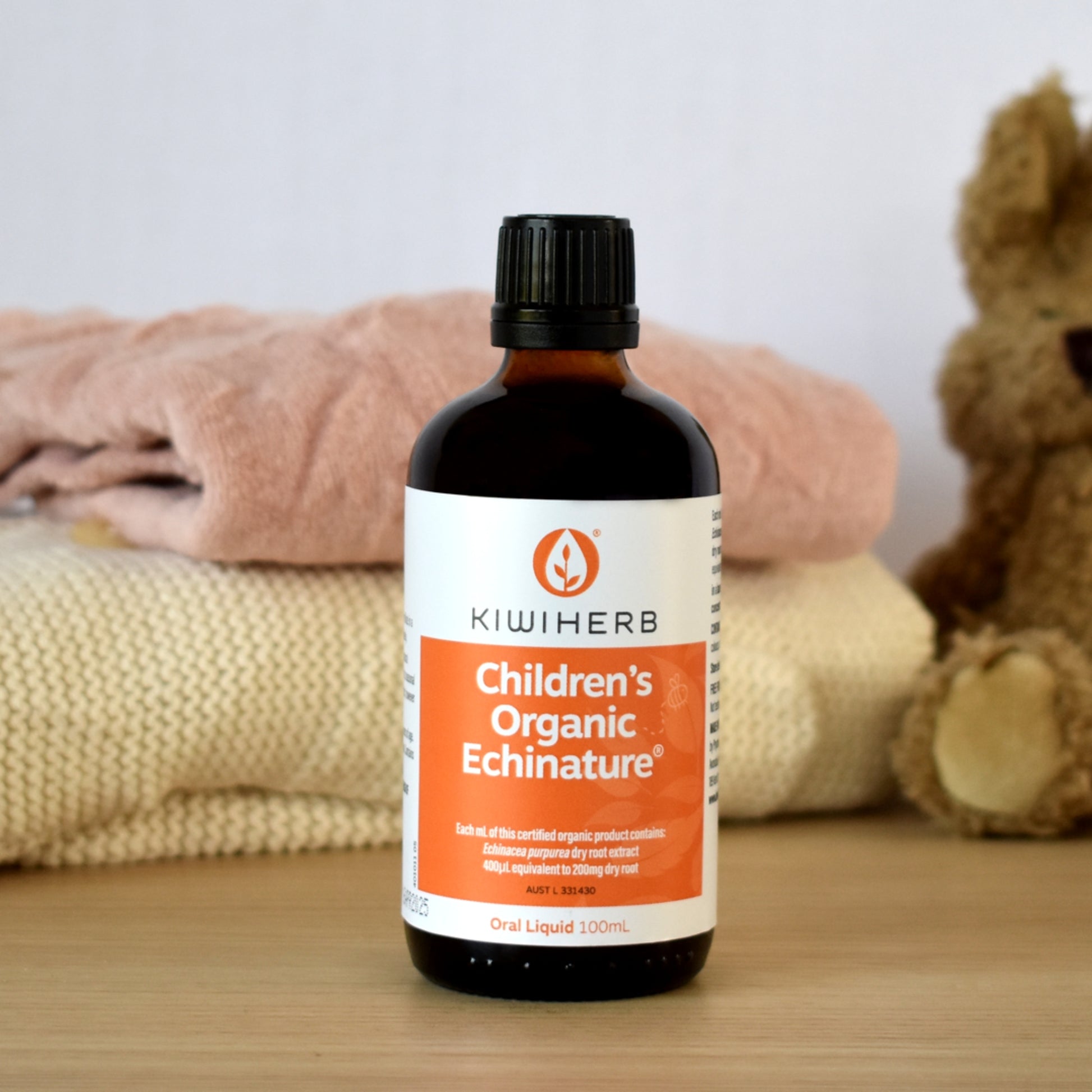 A bottle of Children's Organic Echinature on a wooden table.